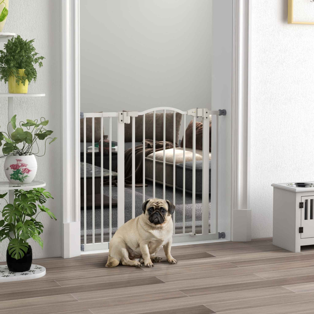 Pug sitting in front of 74-94cm wide dog gate