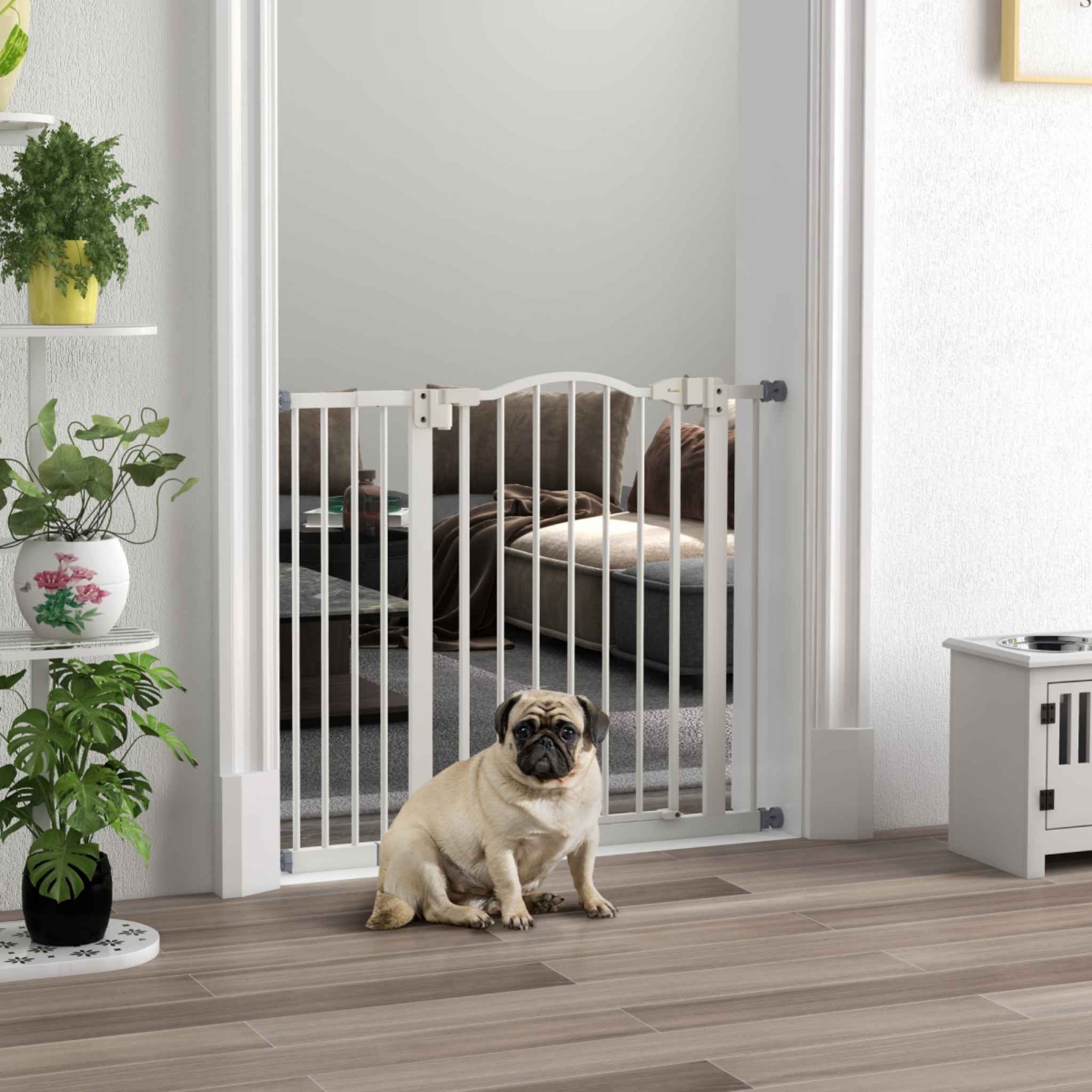 Pug sitting in front of 74-94cm wide dog gate