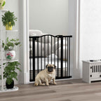 Pug standing in front of black dog safety gate