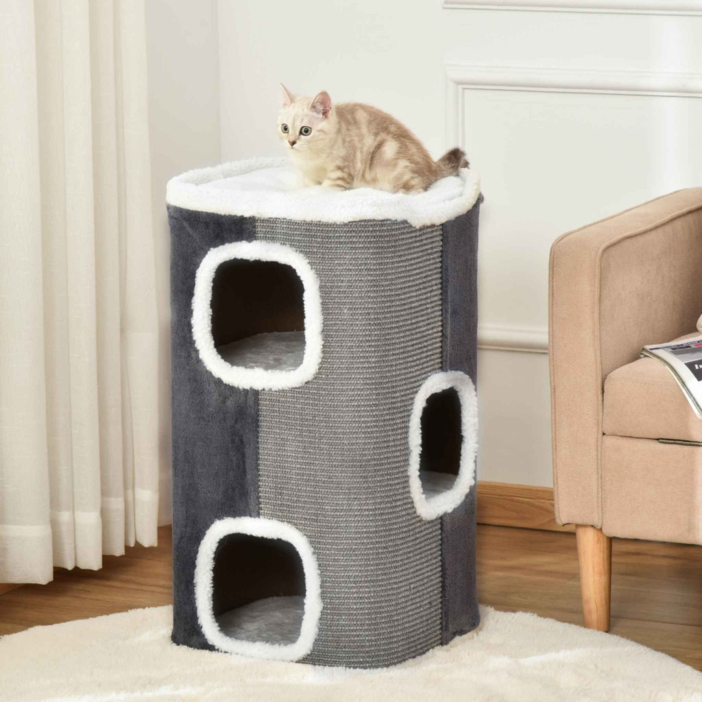 Small cat sitting on top perch of multi level cat scratcher barrel