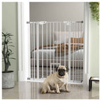 Small dog sitting in front of tall white dog gate