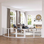 Small dog sitting in living room behind extra wide wooden dog barrier
