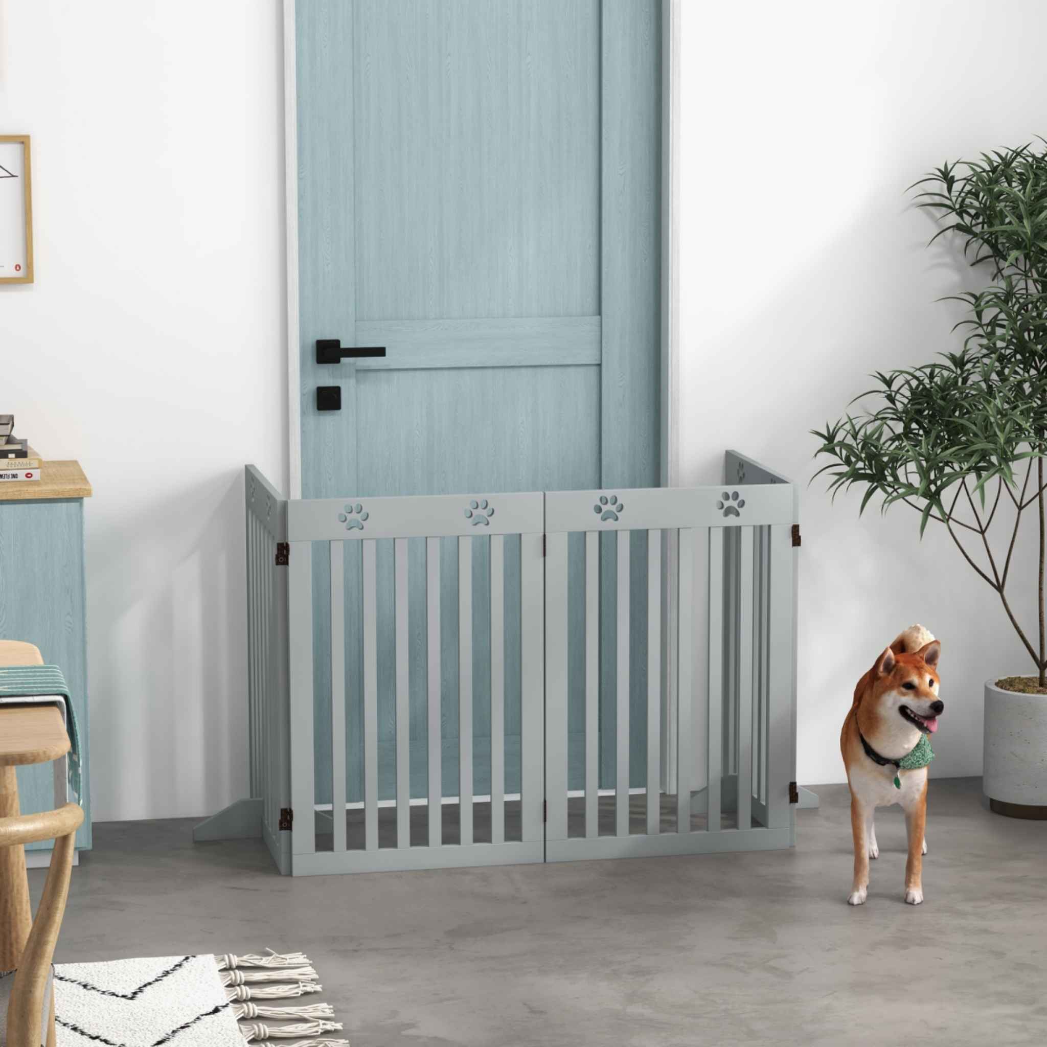 Small dog standing in front of freestanding pet gate in doorway