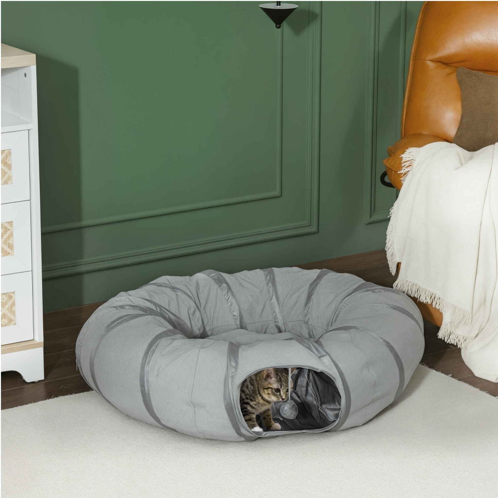 Tabby cat playing in bed tunnel