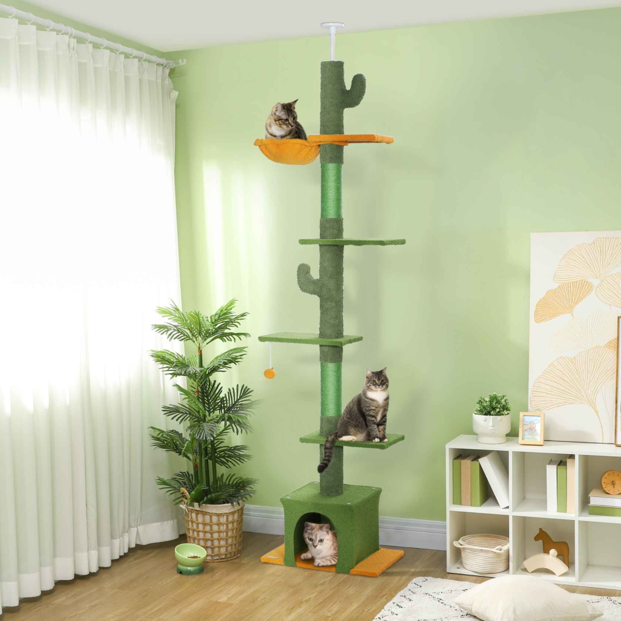 Three cats sitting on floor to ceiling cat tree