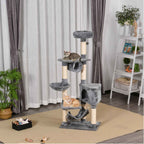Two cats laying on tall grey cat tree in living room