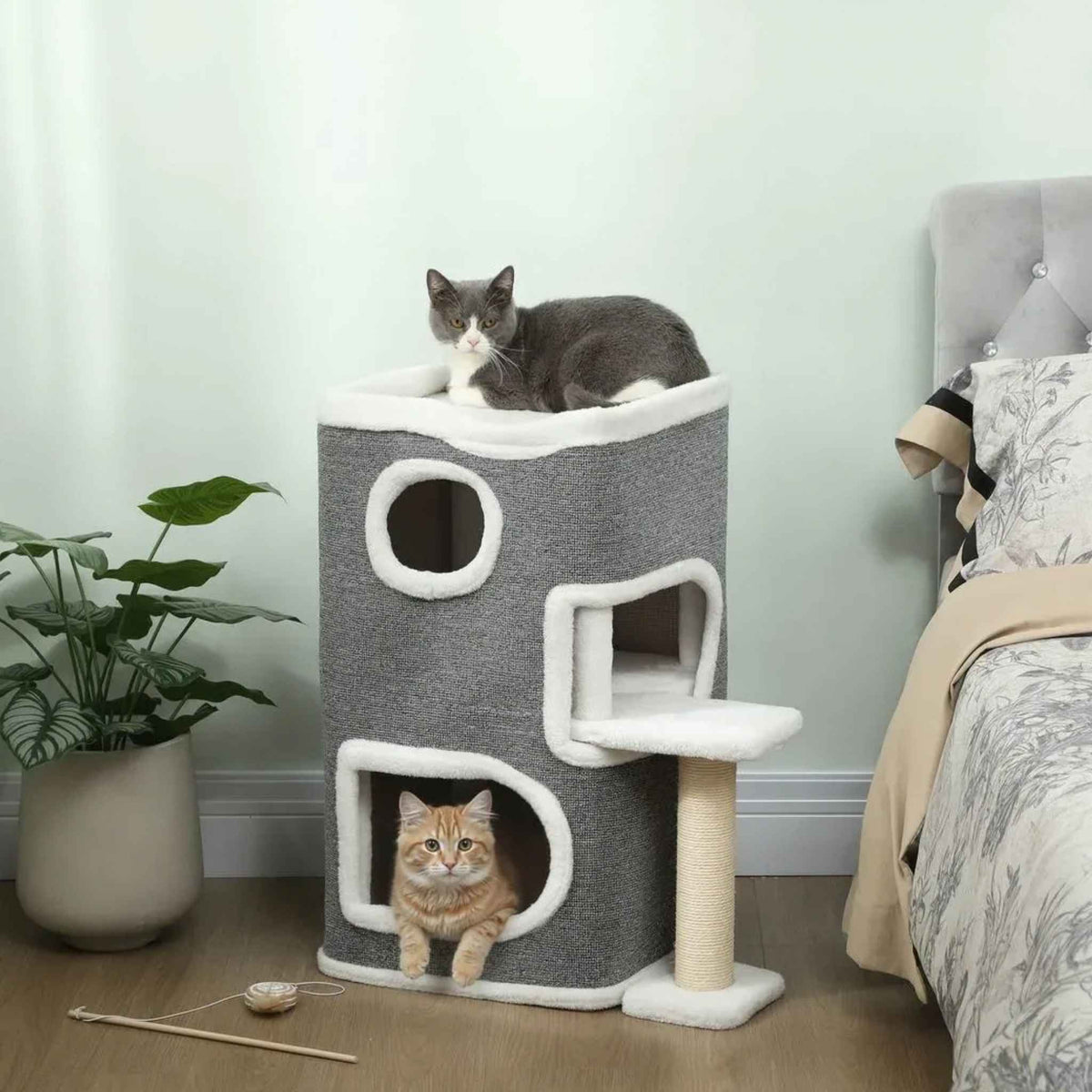 Two cats resting on cat tree house