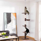 Two cats sitting on floor to ceiling cat tree tower